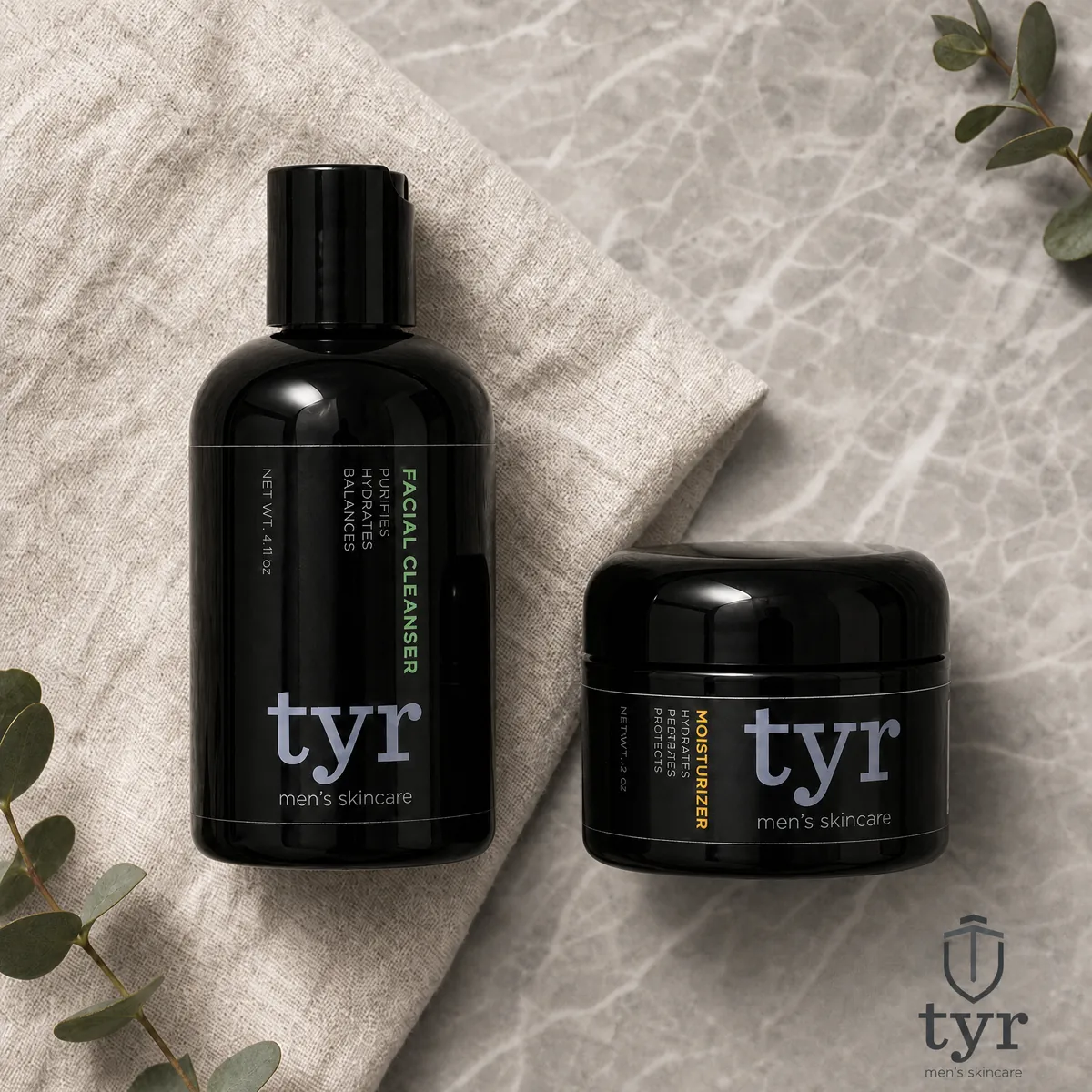 Two black bottles and a jar of tyr men&