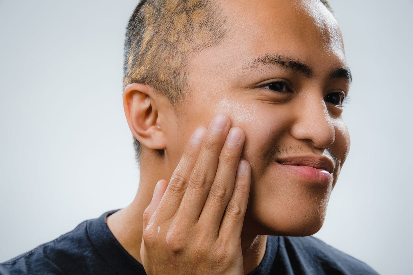 Young asian man talent model using Tyr skincare for men Vitamin C serum, close up angle