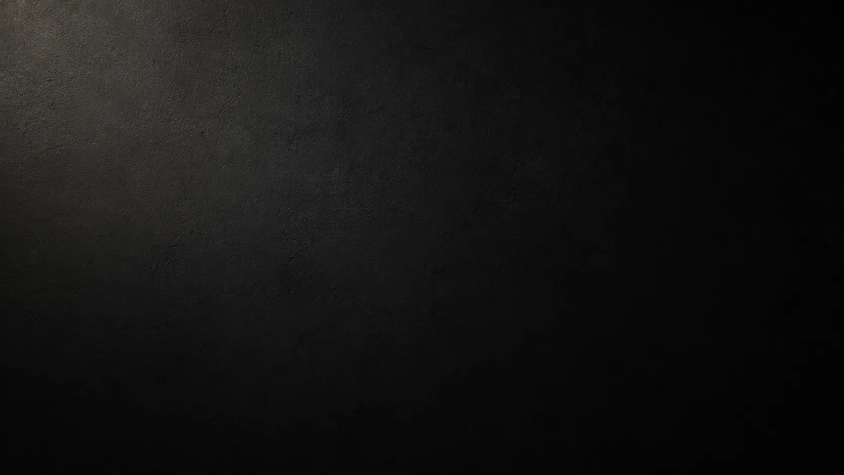 A dark textured background with a subtle vignette effect, fading lighter near the upper left corner.